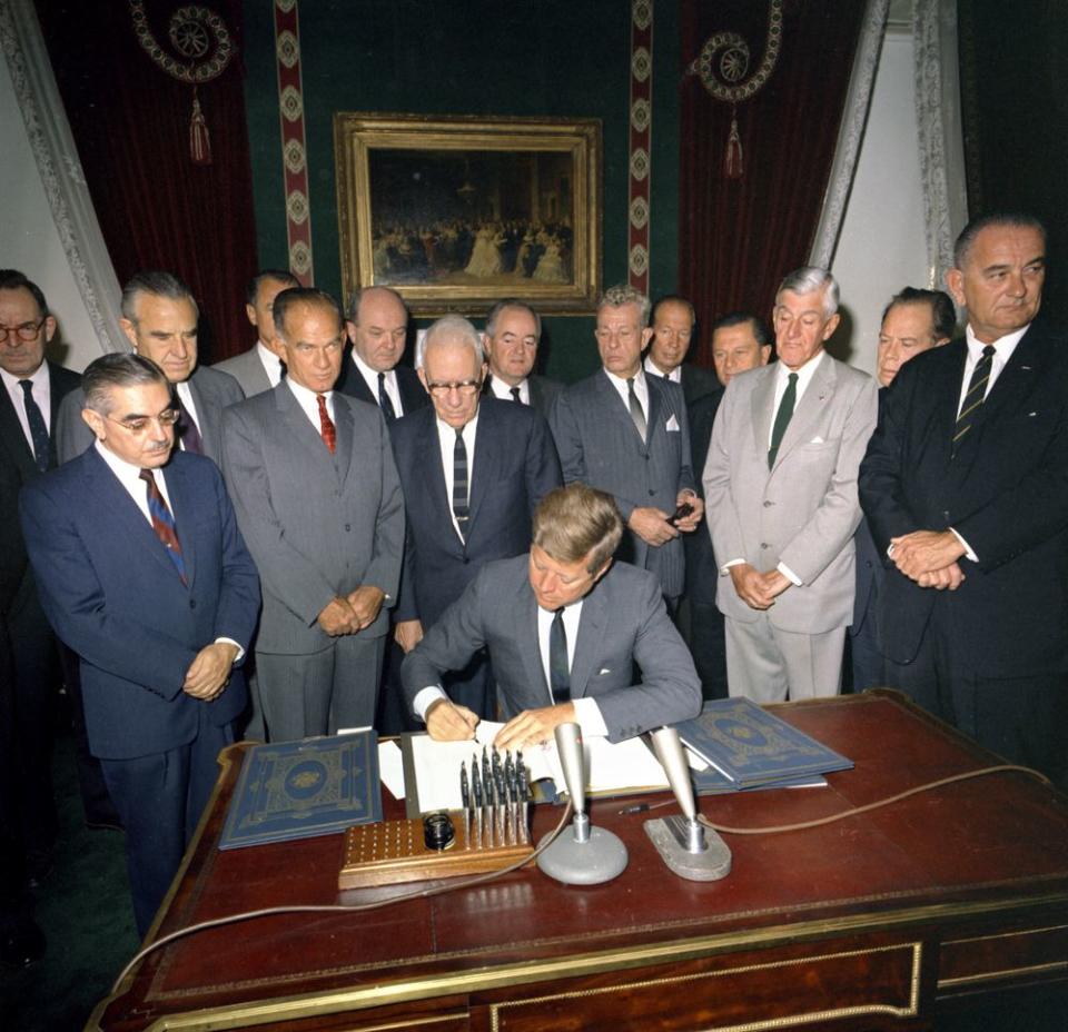 President John F. Kennedy signing the Nuclear Test Ban Treaty, with Vice President Lyndon B. Johnson and others, on Oct. 7, 1963. (Photo: Robert Knudsen/John F. Kennedy Presidential Library and Museum)