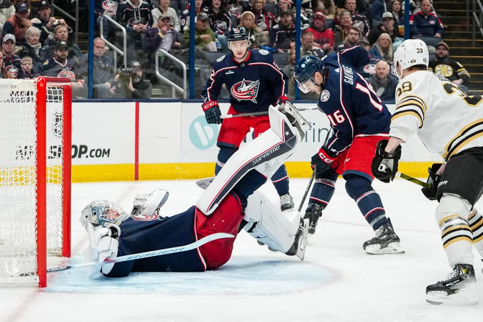 Jan 2, 2024; Columbus, Ohio, USA; Columbus Blue Jackets goaltender Spencer Martin (30) falls on his back as center Brendan Gaunce (16) clears away the puck during the second period of the NHL hockey game against the Boston Bruins at Nationwide Arena.