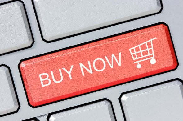 Shop online buy now business concept. Red shopping cart button on the computer keyboard