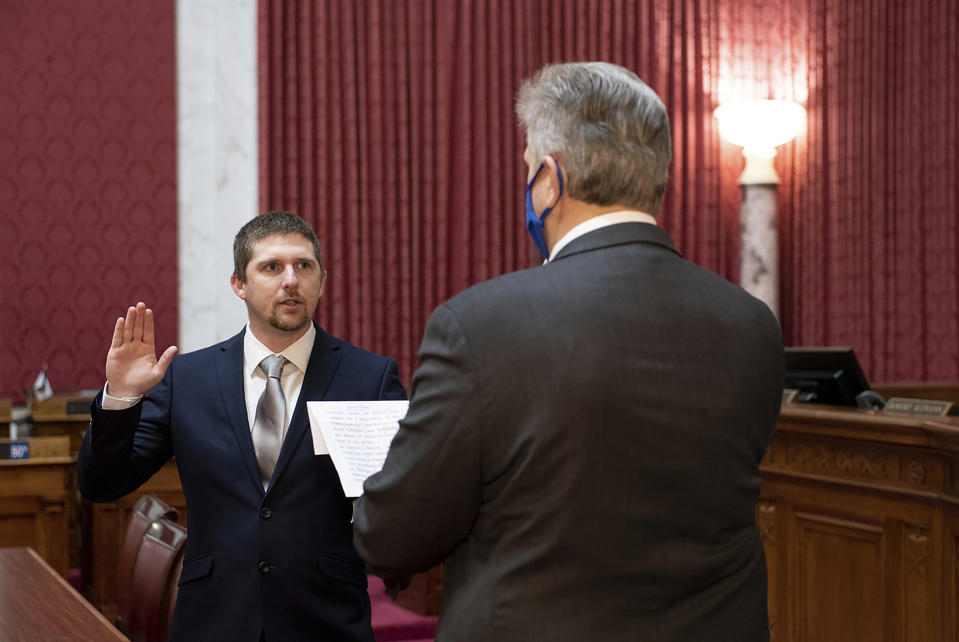 Image: West Virginia House of Delegates member Derrick Evans is given the oath of office Dec. 14, 2020 at the state Capitol in Charleston, W.Va. (Perry Bennett / West Virginia Legislature via AP)