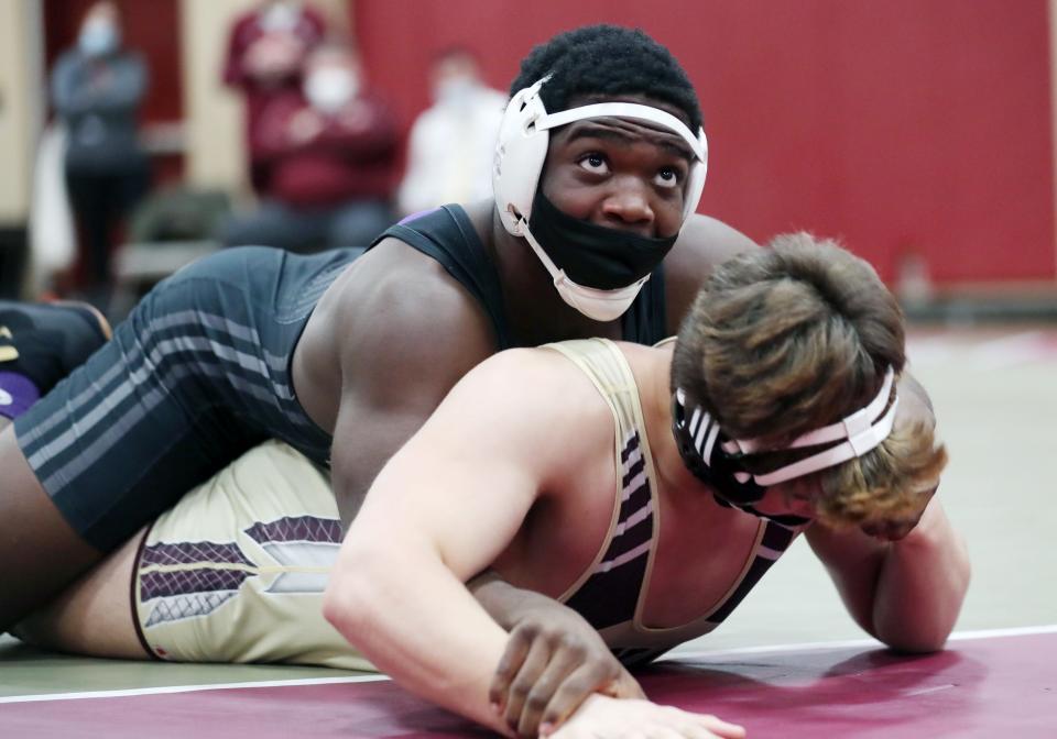 From left, New Rochelle's Steven Burrell on his way to defeating Iona's Gabriel Garibaldi in the 215-pound weight class during wrestling action at Iona Prep Dec. 1, 2021.