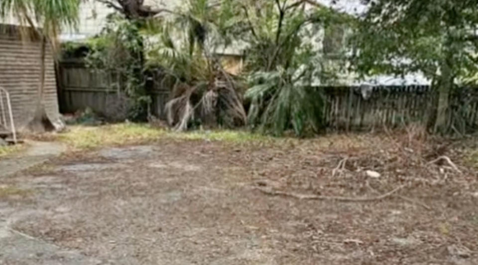 A concrete slab in a back yard.