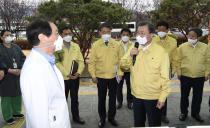 South Korean President Moon Jae-in, front right, talks to a president of Daegu Medical Center, You Wansik, at the Daegu Medical Center in Daegu, South Korea, Tuesday, Feb. 25, 2020. China and South Korea on Tuesday reported more cases of a new viral illness that has been concentrated in North Asia but is causing global worry as clusters grow in the Middle East and Europe. (Bae Hun-shik/Newsis via AP)