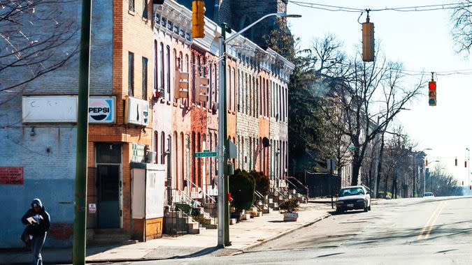 Baltimore, Maryland, USA - Postman on the street somewhere in West Baltimore, typical inner city neighbourhood with row houses.