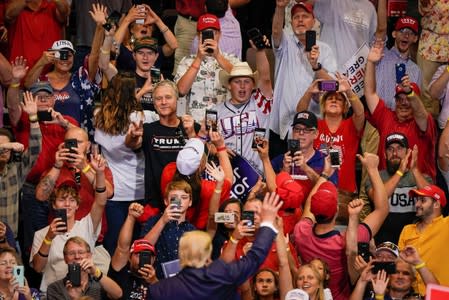 U.S. President Donald Trump acknowledges supporters as he departs a campaign rally in Cincinnati