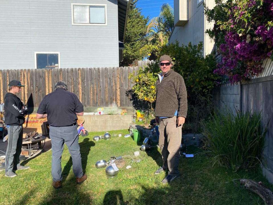 Tim Nelligan, right, stands with Steve Hoyt, center and his son, Mason Nelligan, as they install soil vapor probes in Marcia Papich’s yard in December 2020. They were testing for evidence of human decomposition in the search for Kristin Smart’s body.