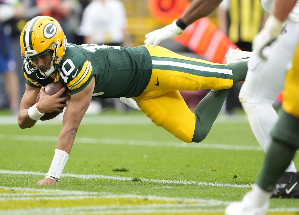 GREEN BAY, WISCONSIN – SEPTEMBER 24: Jordan Love #10 of the Green Bay Packers dives into the end zone while scoring a rushing touchdown during the fourth quarter against the New Orleans Saints at Lambeau Field on September 24, 2023 in Green Bay, Wisconsin. (Photo by Patrick McDermott/Getty Images)