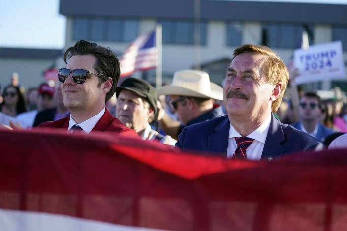 Rep. Matt Gaetz, R-Fla., left, and My Pillow CEO Mike Lindell listen as former President Donald Trump speaks at a campaign rally at Waco Regional Airport, Saturday, March 25, 2023, in Waco, Texas. (AP Photo/Evan Vucci)