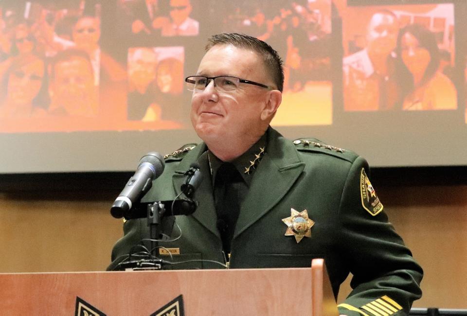Shasta County Sheriff Michael Johnson looks at the crowd that filled the Board of Supervisors chambers Friday, Aug. 13, 2021, after he was sworn in as the county's 23rd sheriff. A slide show in the background showed photos of Johnson's family.