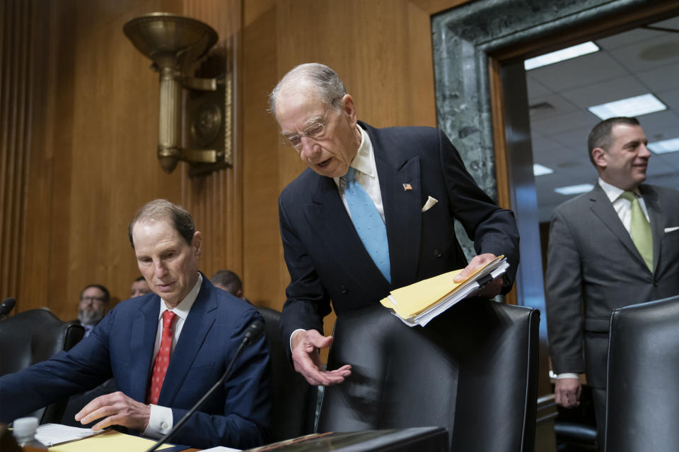 Sen. Chuck Grassley, R-Iowa, chairman of the Senate Finance Committee, center, joined at left by Sen. Ron Wyden, D-Ore., the ranking member, arrives for the start of a hearing called "Challenges in the Retirement System," on Capitol Hill in Washington, Tuesday, May 14, 2019. (AP Photo/J. Scott Applewhite)