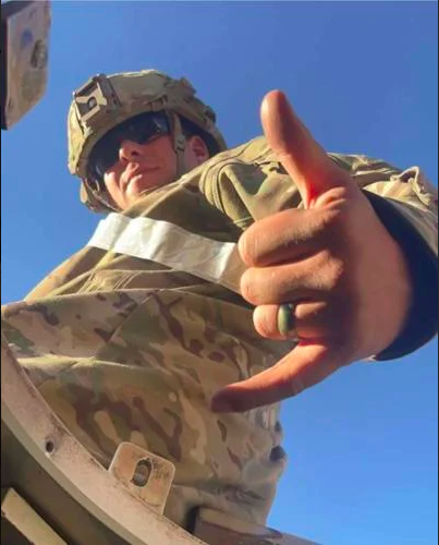 Braden Peltier poses for a photo, showing off his wedding band, while on the Army base in Colorado.