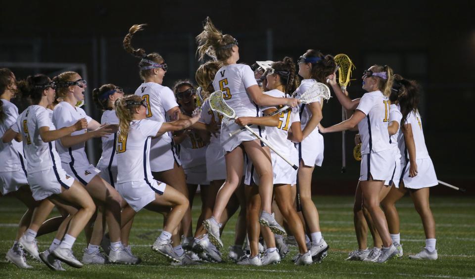 Victor players celebrate around goalie Kennedy Schottland as time expires giving them the victory in the Section V Class B girls lacrosse championship final over Canandaigua 9-5, Wednesday, June 1, 2022 at East Rochester High School. 