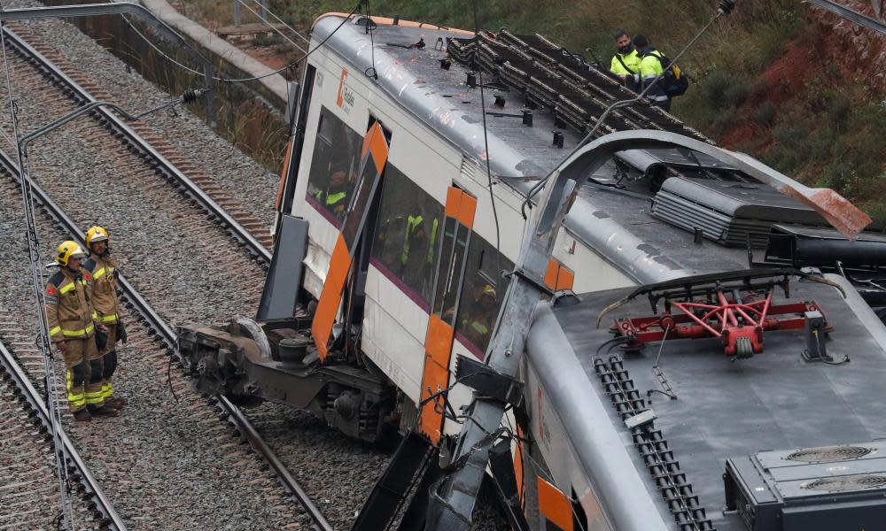 Rescue workers at the scene of a train derailment in Catalonia