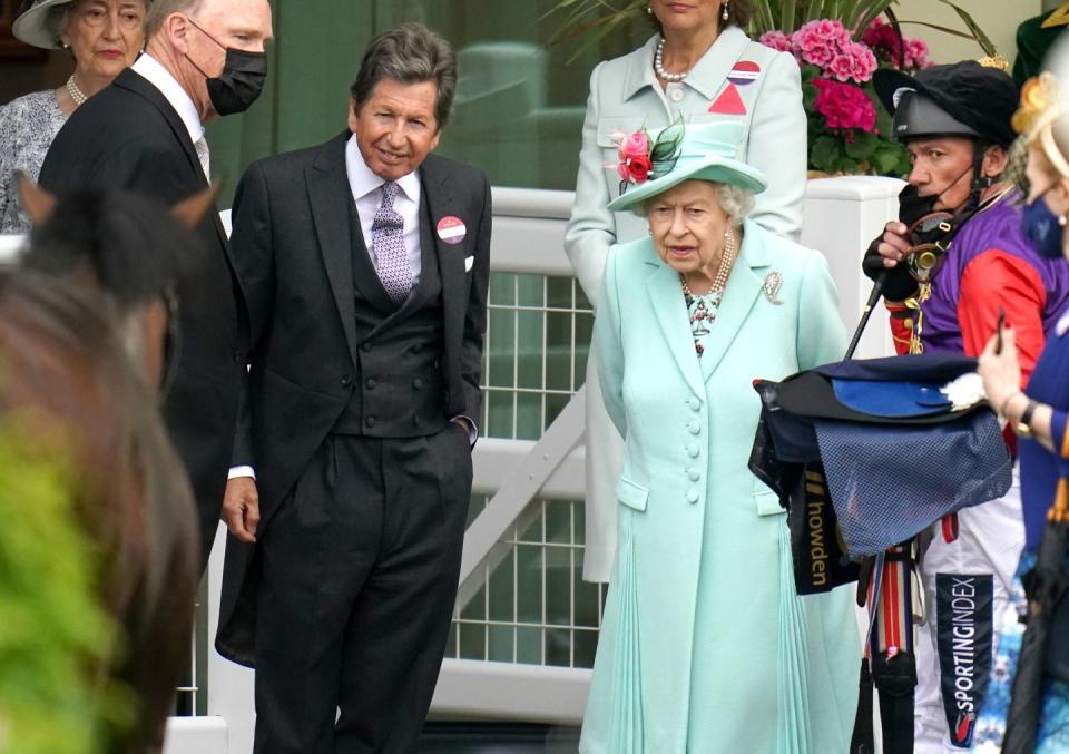 <p>The monarch with her racing manager John Warren and jockey Frankie Dettori as they inspect the horse Reach For The Moon.</p>