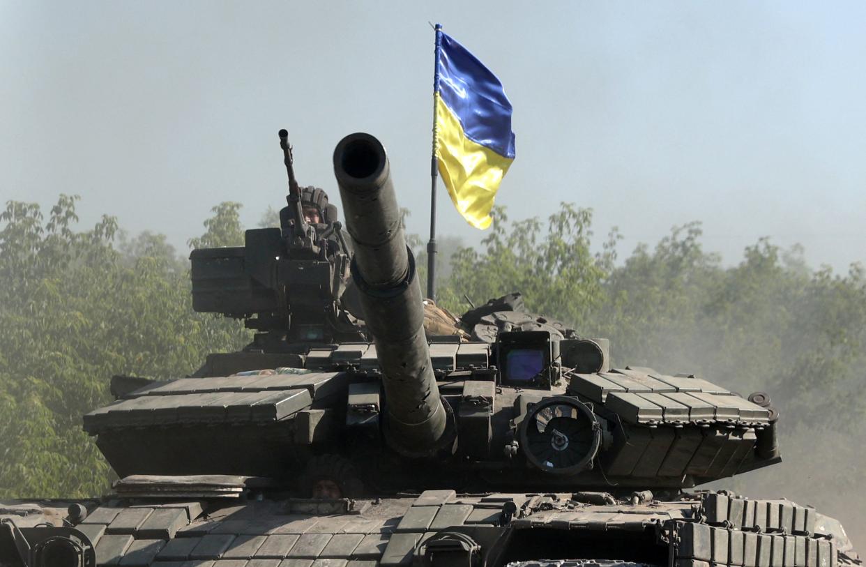 Ukrainian troop ride a tank on a road of the eastern Ukrainian region of Donbas on June 21, 2022, as Ukraine says Russian shelling has caused "catastrophic destruction" in the eastern industrial city of Lysychansk, which lies just across a river from Severodonetsk where Russian and Ukrainian troops have been locked in battle for weeks. 