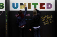 People write on a message wall during the "Aggies United" official school event outside Kyle Field at Texas A&M University, before a separate event not sanctioned by the school on campus where white nationalist leader Richard Spencer of the National Policy Institute is due to speak, in College Station, Texas, U.S. December 6, 2016. REUTERS/Spencer Selvidge