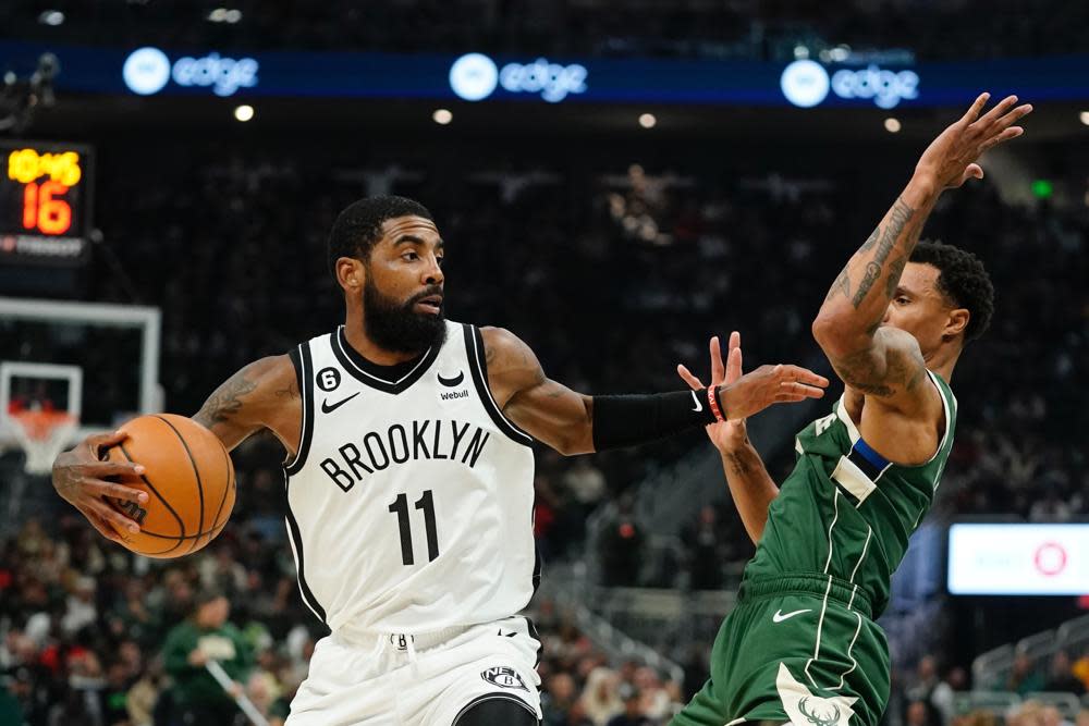 Brooklyn Nets’ Kyrie Irving tries to get past Milwaukee Bucks’ George Hill during the first half of an NBA basketball game Wednesday, Oct. 26, 2022, in Milwaukee. (AP Photo/Morry Gash)
