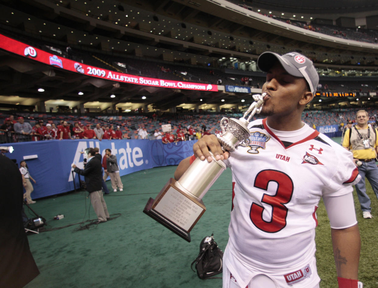 Utah quarterback Brian Johnson (3) kisses his Sugar Bowl MVP trophy after his NCAA football game in the Sugar Bowl in New Orleans, Saturday, Jan. 3, 2009.  Utah defeated Alabama 31-17. (AP Photo/Dave Martin)