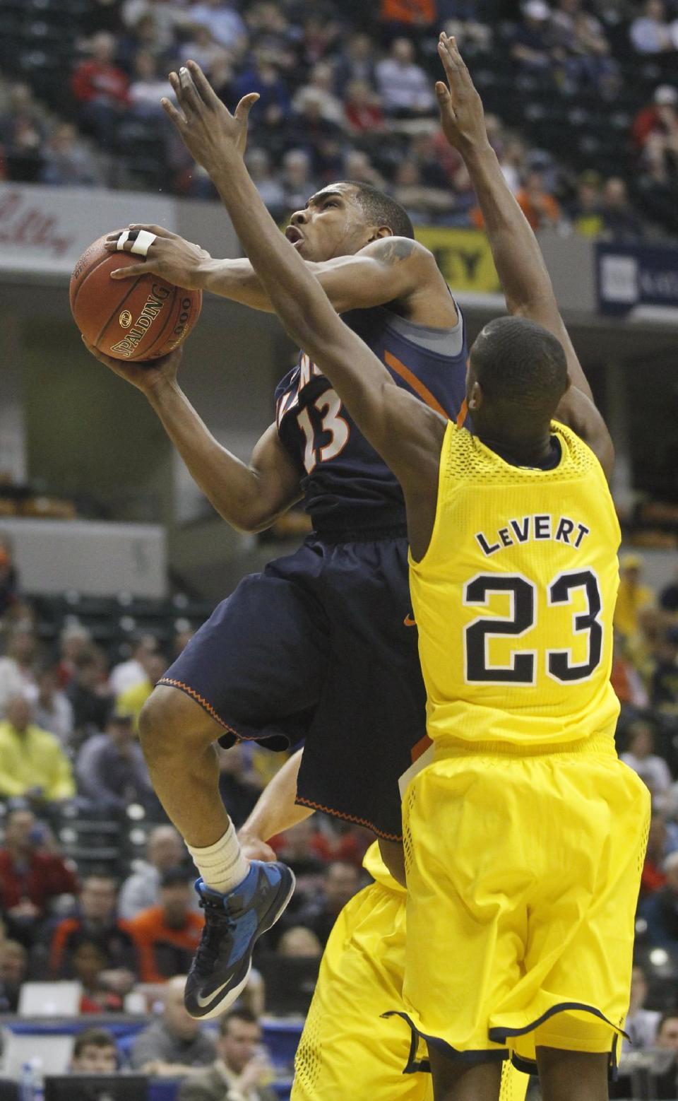 Illinois guard Tracy Abrams (13) goes up for a shot against Michigan guard Caris LeVert (23) in the first half of an NCAA college basketball game in the quarterfinals of the Big Ten Conference tournament Friday, March 14, 2014, in Indianapolis. (AP Photo/Kiichiro Sato)