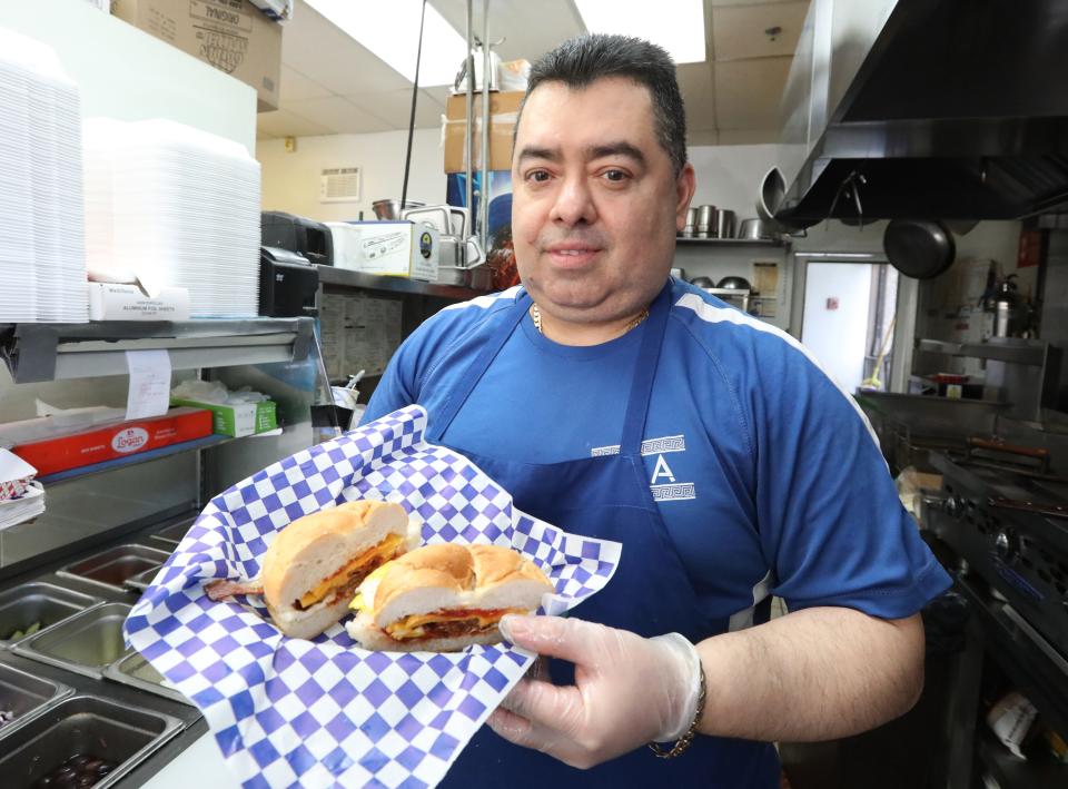 Owner Frank Ruiz shows off a fresh bacon, egg and cheese sandwich at Opa Breakfast & Sandwich Shop in New City on May 2, 2024.