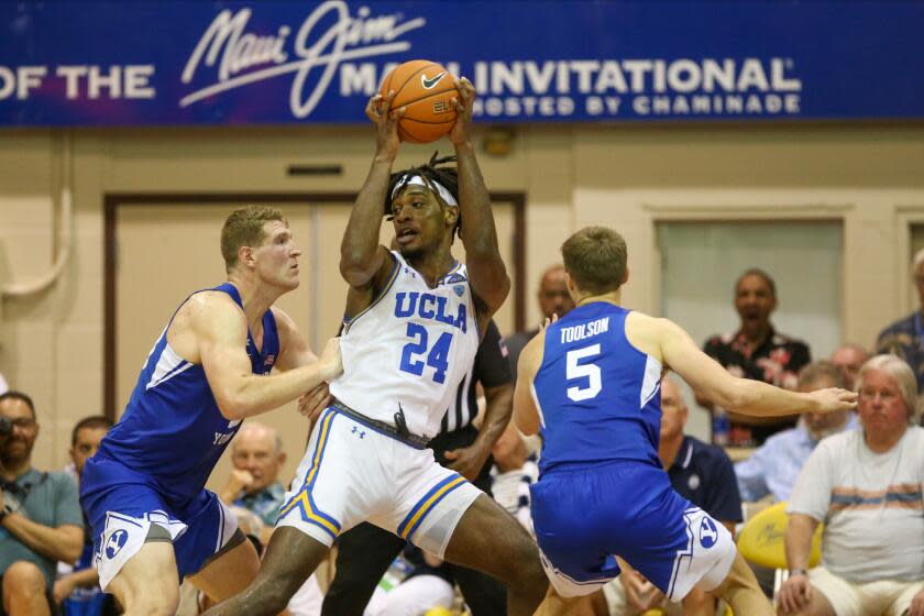 LAHAINA, HI - NOVEMBER 25: Jalen Hill #24 of the UCLA Bruins is defended by Kolby Lee #40 and Jake Toolson #5 of the BYU Cougars during the second half at the Lahaina Civic Center on November 25, 2019 in Lahaina, Hawaii. (Photo by Darryl Oumi/Getty Images)