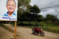 A campaign poster of Nasry Asfura, presidential candidate of the National Party of Honduras, is seen on the side of a road in Catacamas