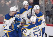 Buffalo Sabres' Tage Thompson (72) celebrates with teammates Mattias Samuelsson (23), Vinnie Hinostroza, Jeff Skinner (53) and Rasmus Dahlin (26) after scoring against the Montreal Canadiens during the third period of an NHL hockey game in Montreal, Tuesday, Nov. 22, 2022. (Graham Hughes/The Canadian Press via AP)