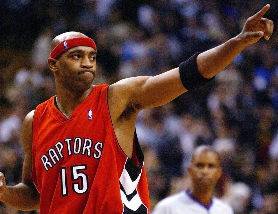 TORONTO - NOVEMBER 3:   Vince Carter #15 of the Toronto Raptors salutes the crowd after beating the Houston Rockets 95-88 during a game at the Air Canada Centre on November 3, 2003 in Toronto, Canada.  NOTE TO USER: User expressly acknowledges and agrees that, by downloading and or using this photograph, User is consenting to the terms and conditions of the Getty Images License Agreement. (Photo by Dave Sandford/Getty Images)