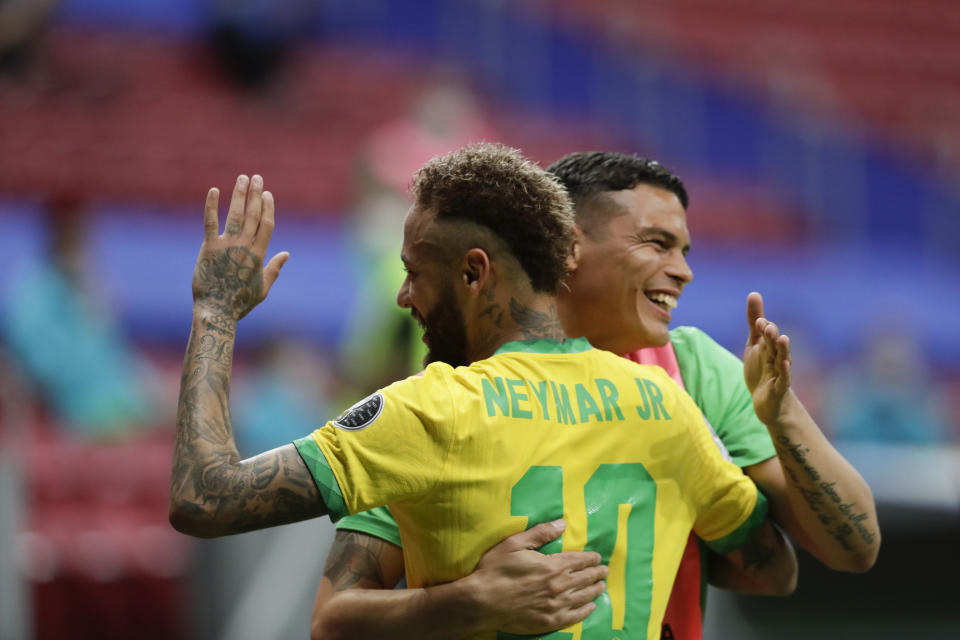 Brazil's Neymar, left, celebrates scoring his side's second goal against Venezuela on a penalty kick with teammate Thiago Silva during a Copa America soccer match at the National Stadium in Brasilia, Brazil, Sunday, June 13, 2021. (AP Photo/Eraldo Peres)