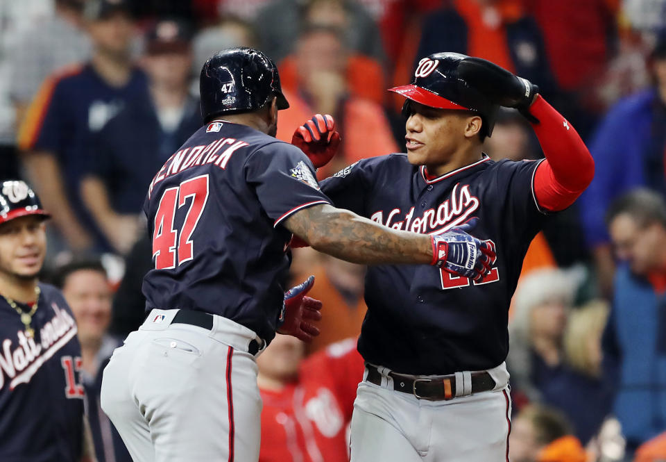 HOUSTON, TEXAS - OCTOBER 30:  Howie Kendrick #47 of the Washington Nationals is congratulated by his teammate Juan Soto #22 after hitting a two-run home run against the Houston Astros during the seventh inning in Game Seven of the 2019 World Series at Minute Maid Park on October 30, 2019 in Houston, Texas. (Photo by Elsa/Getty Images)