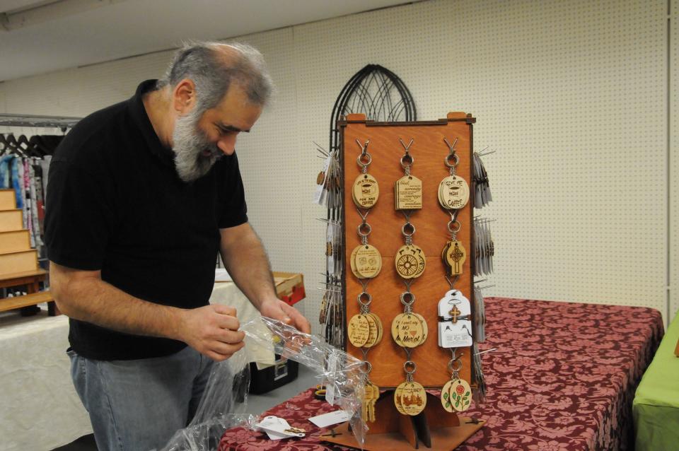 Pittsburgh vender Michael Greenstein sets up his table in Glades Court Mall at Fire and Ice Festival.