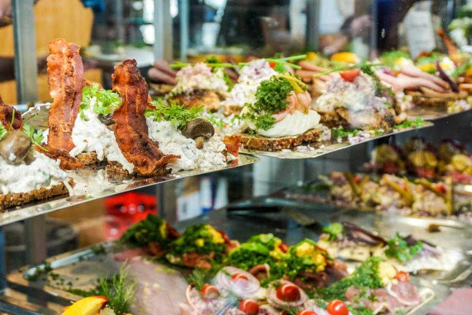 A market in Copenhagen offers a selection of Smørrebrød, traditional Danish open-faced sandwiches