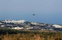 An aircraft flies over a base for U.N. peacekeepers of the United Nations Interim Force in Lebanon (UNIFIL) in Naqoura