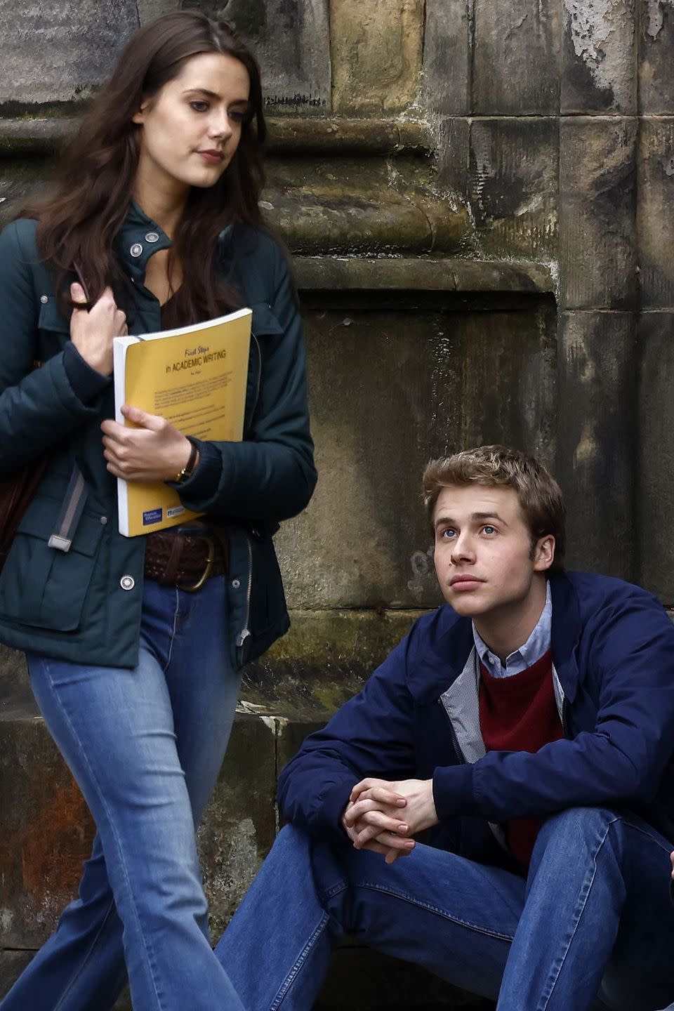 a woman and a man sitting on a bench