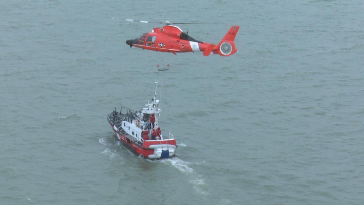 A U.S. Coast Guard helicopter performs a training exercise with the Canadian Coast Guard in this file photo. The two joined forces for a search for a missing American kayaker who was found dead Monday. (Jason Viau/CBC - image credit)
