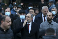 Armenian Prime Minister Nikol Pashinyan greets his supporters during a rally in his support in the center of Yerevan, Armenia, Monday, March 1, 2021. Amid escalating political tensions in Armenia, supporters of the country's embattled prime minister and the opposition are staging massive rival rallies in the capital of Yerevan. Prime Minister Nikol Pashinyan has faced opposition demands to resign since he signed a peace deal in November that ended six weeks of intense fighting with Azerbaijan over the Nagorno-Karabakh region. (Stepan Poghosyan/PHOTOLURE via AP)