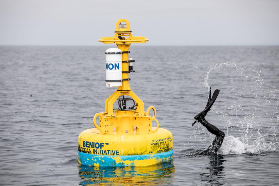 Douglas McCauley inspects an acoustical buoy that helps track whale activity offshore of San Francisco. Each year, more than 80 whales die after being struck by ships off the West Coast.