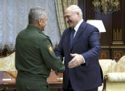 Belarusian President Alexander Lukashenko, right, greets Russian Defense Minister Sergei Shoigu during their meeting in Minsk, Belarus, Wednesday, Sept. 16, 2020. Sergei Naryshkin, director of Russia's Foreign Intelligence Service, on Wednesday accused the United States of fomenting massive demonstrations against Belarus' authoritarian president that have entered their sixth week. (Maxim Guchek/BelTA Pool Photo via AP)