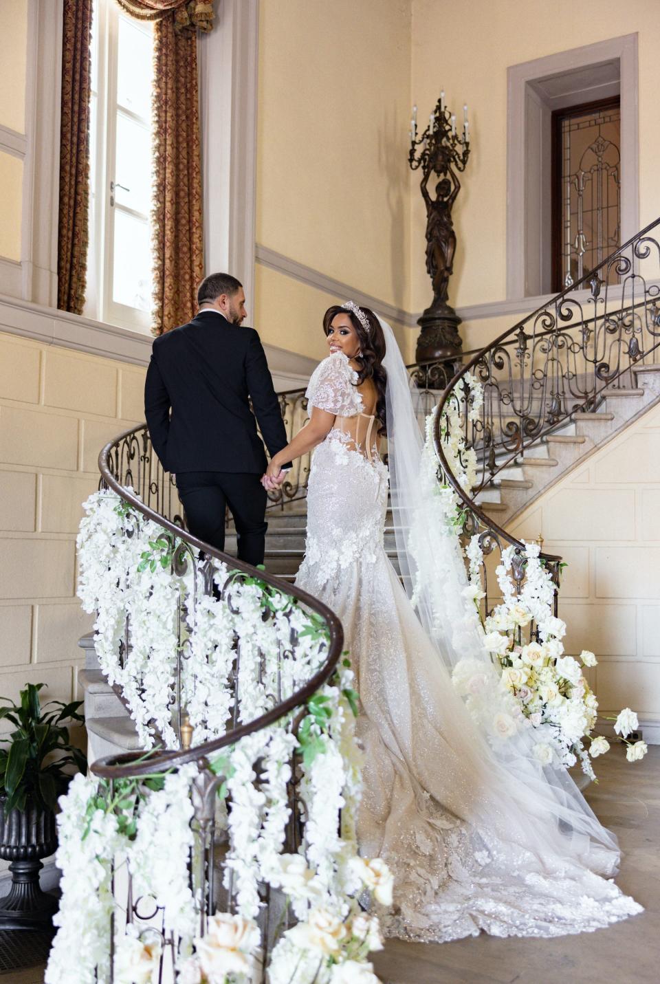 Vishnell and her husband walk up a staircase on their wedding day