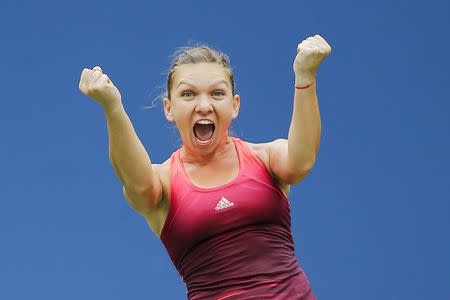 Simona Halep of Romania celebrates her victory over Victoria Azarenka of Belarus during their quarterfinals match at the U.S. Open Championships tennis tournament in New York, September 9, 2015. REUTERS/Eduardo Munoz