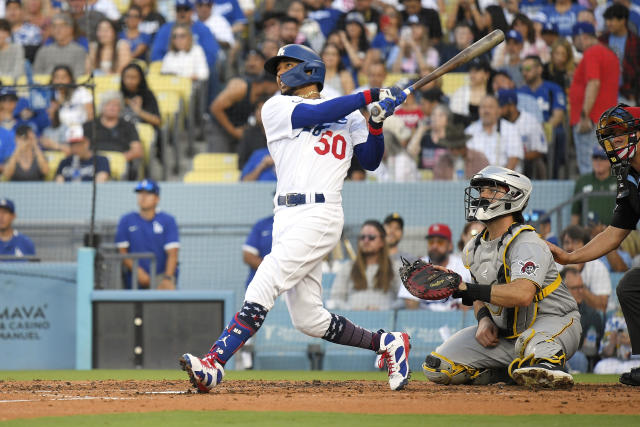 Los Angeles Dodgers' David Peralta, right, gestures to fans as he scores  after hitting a solo home run while Pittsburgh Pirates catcher Austin  Hedges stands by during the fifth inning of a