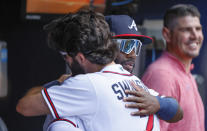 Atlanta Braves center fielder Michael Harris II, front right, making his Major League Baseball debut, gets a welcome hug from Dansby Swanson before a baseball game against the Miami Marlins, Saturday, May 28, 2022, in Atlanta. (AP Photo/Bob Andres)