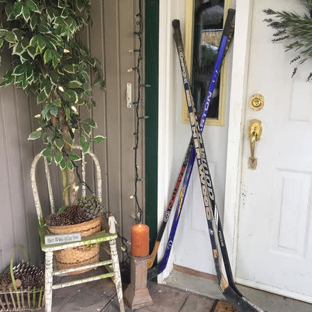 Hockey sticks are seen on a porch in tribute to the 15 youth players and personnel killed in a bus crash, in Qualicum Beach, British Columbia, Canada April 9, 2018 in this picture obtained from social media. INSTAGRAM/@LEMCCORMICK via REUTERS