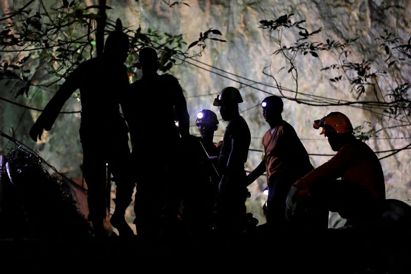 FILE PHOTO: Rescue workers take a rest as they take out machines after 12 soccer players and their coach were rescued in Tham Luang cave complex in the northern province of Chiang Rai