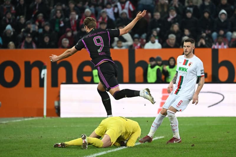Bayern Munich's Harry Kane (above) and Augsburg goalkeeper Finn Dahmen in action during the German Bundesliga soccer match between FC Augsburg and Bayern Munich at the WWK-Arena. Sven Hoppe/dpa