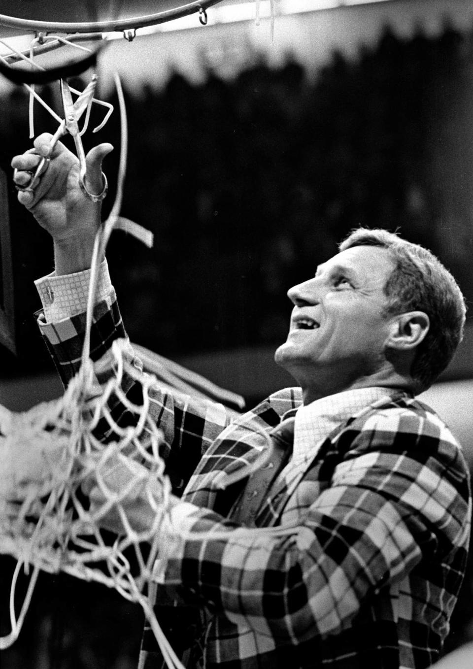 NC coach Norm Sloan cuts down the nets after the Wolfpack defeated Marquette to win the 1974 National Championship.