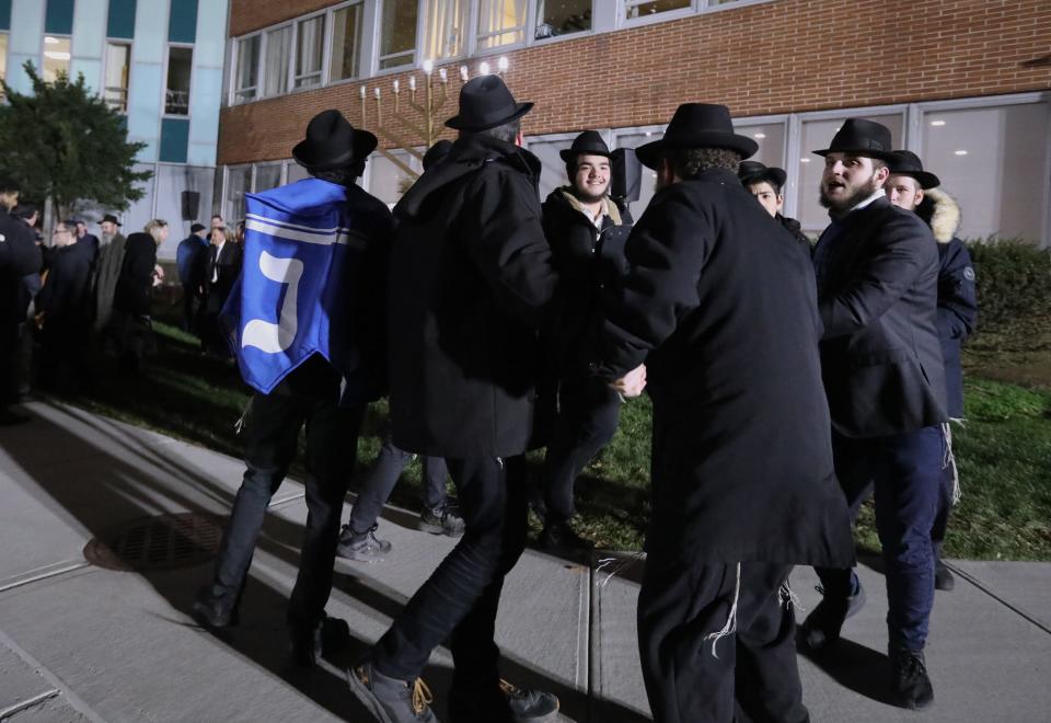 People dance in front of the Hanukkah menorah at the Allison-Parris Rockland County Office Building in New City Dec. 19, 2022. Chabad of Rockland sponsored the event.