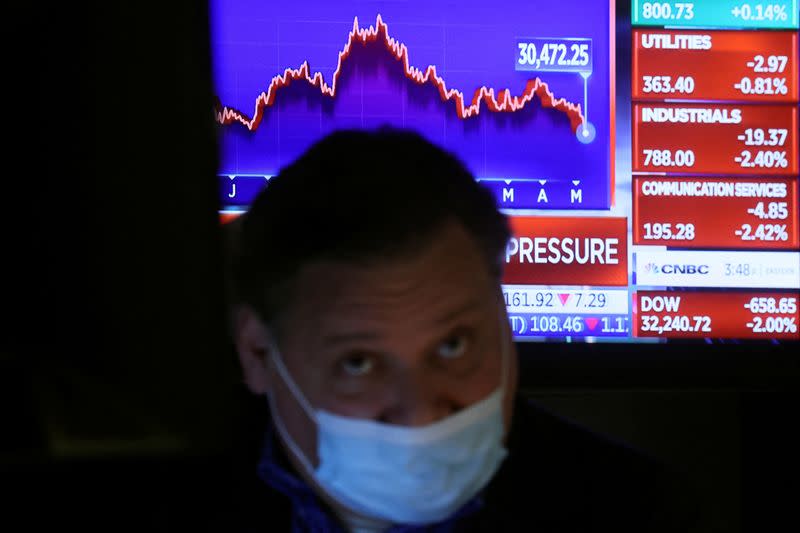 Traders work on the floor of the NYSE in New York