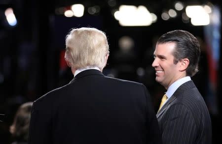 FILE PHOTO: Republican U.S. presidential nominee Donald Trump (L) talks with his son Donald Trump Jr. (R) after his debate against Democratic nominee Hillary Clinton at Hofstra University in Hempstead, New York, U.S. September 26, 2016. REUTERS/Joe Raedle/POOL/File Photo