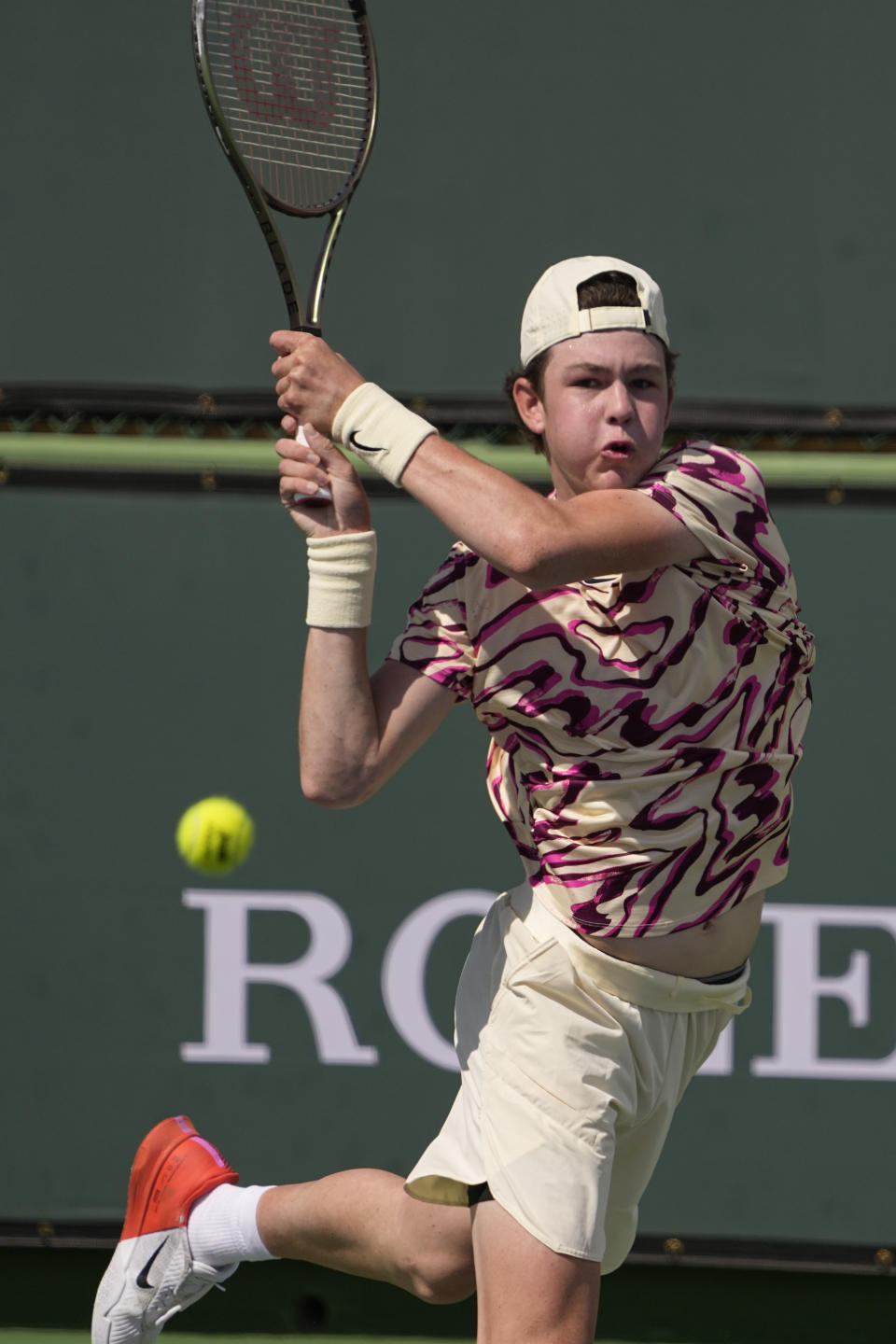 Jagger Leach returns a shot to Stiles Brockett at the BNP Paribas Open tennis tournament Wednesday, March 15, 2023, in Indian Wells, Calif. 15-year-old son of Lindsay Davenport, a three-time major champion and former No. 1-ranked player. Leach has won three ITF World Tennis Tour junior titles this year.(AP Photo/Mark J. Terrill)